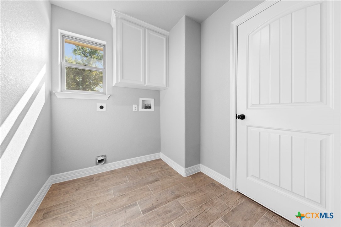 3030 Millhouse Road Copperas Cove, TX 76522 - Photo 19 of 24 an empty room with wooden floor and windows