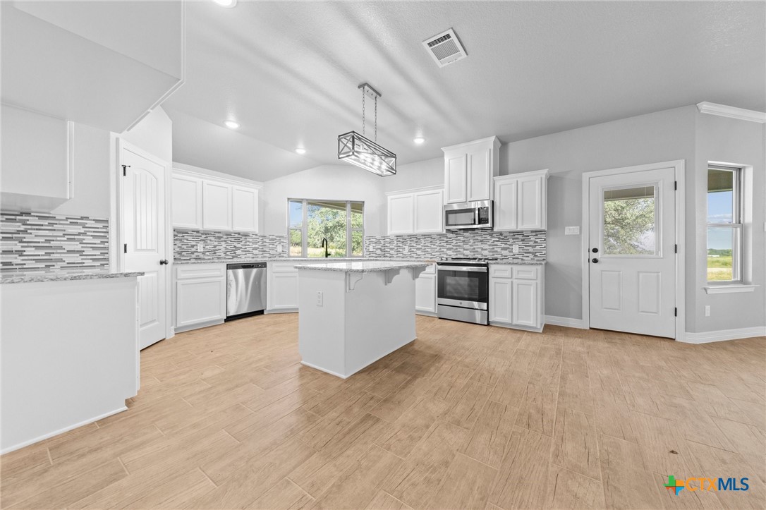 3030 Millhouse Road Copperas Cove, TX 76522 - Photo 6 of 24 a view of a kitchen with a sink cabinets and a window