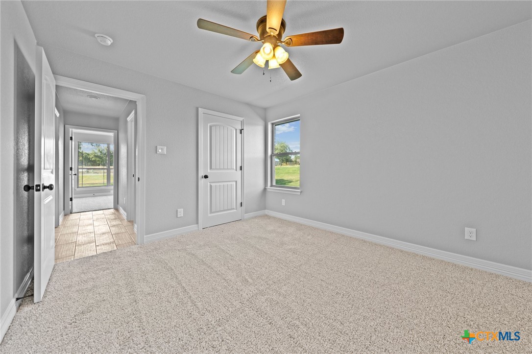 3030 Millhouse Road Copperas Cove, TX 76522 - Photo 8 of 24 wooden floor in an empty room with a chandelier fan