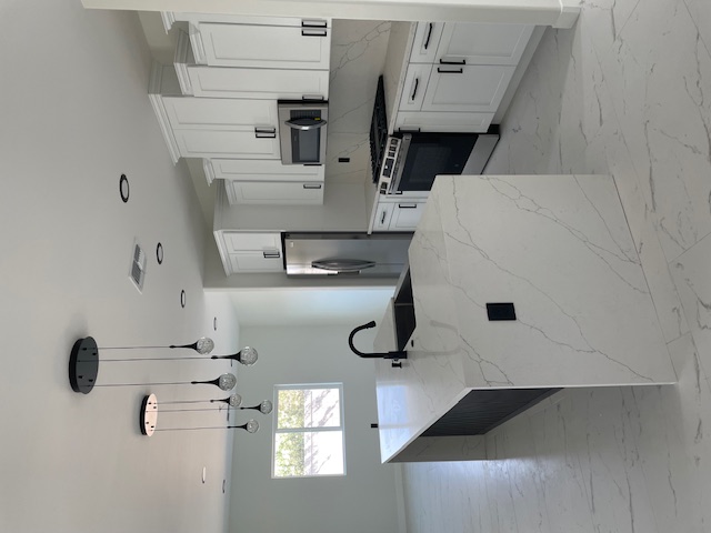 2367 Corwin Road Bullhead City, AZ 86442 - Photo 8 of 45 a kitchen with kitchen island white cabinets and stainless steel appliances
