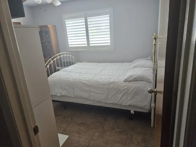 a bedroom with a bed and a window