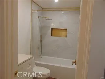 a bathroom with a shower a toilet and a sink