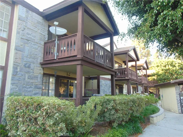 a view of a brick building with large windows and a table and chairs