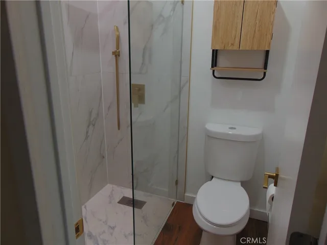 a bathroom with a toilet and a shower curtain