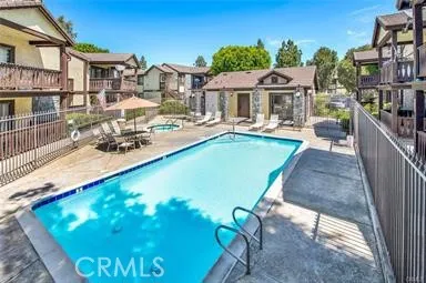 a view of a backyard with table and chairs and potted plants