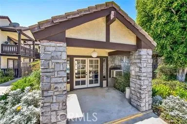 a view of a house with a small yard and plants