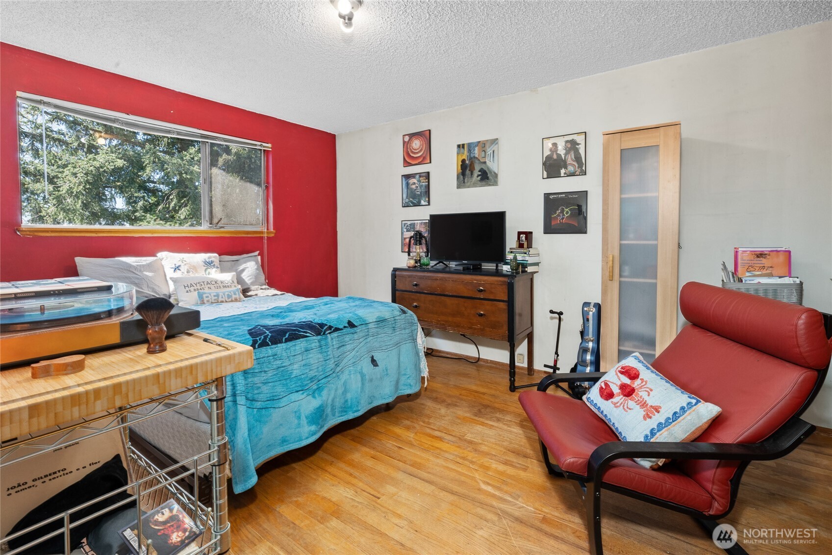 513 Harrington Avenue Northeast Renton, WA 98056 - Photo 18 of 33 a bedroom with a bed and a flat screen tv