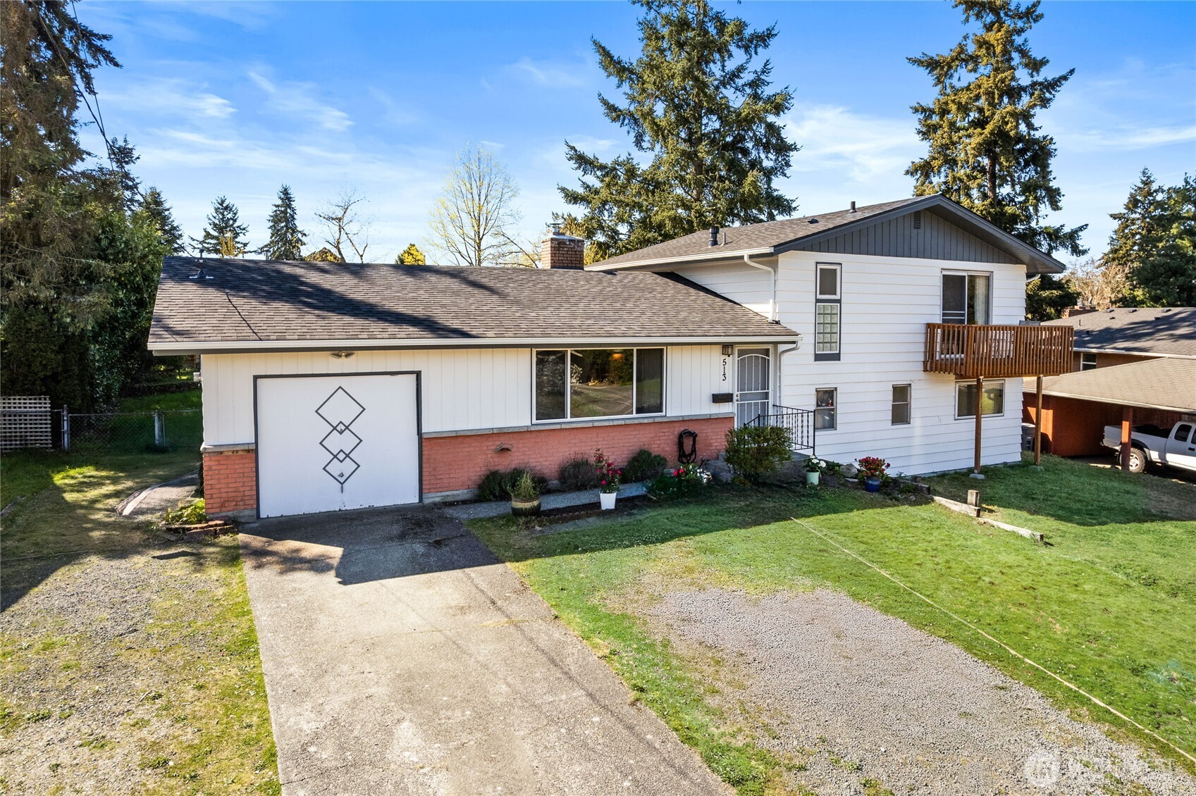 513 Harrington Avenue Northeast Renton, WA 98056 - Photo 2 of 33 a front view of a house with a garden and deck