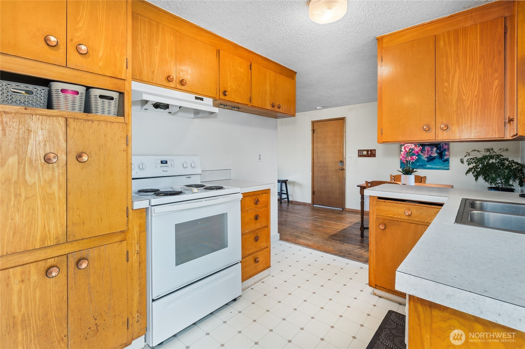 513 Harrington Avenue Northeast Renton, WA 98056 - Photo 9 of 33 a kitchen with stainless steel appliances granite countertop a sink a stove wooden cabinets and a refrigerator