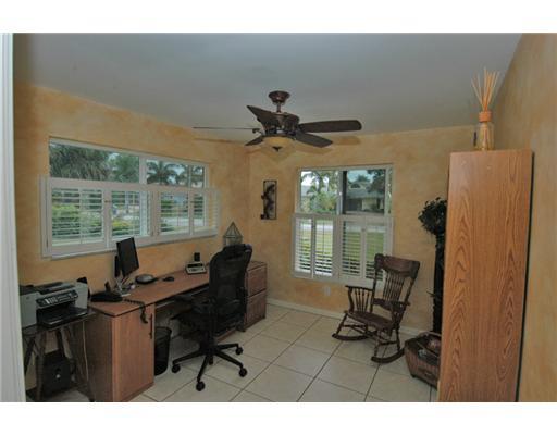 112 Northwest S Shore Road Stuart, FL 34994 - Photo 13 of 16 a living room with furniture and floor to ceiling windows