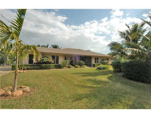112 Northwest S Shore Road Stuart, FL 34994 - Photo 2 of 16 a front view of a house with a garden