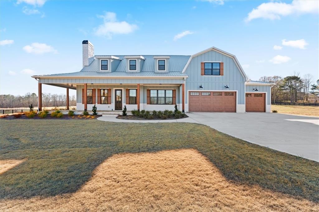 a front view of a house with a yard and lake view