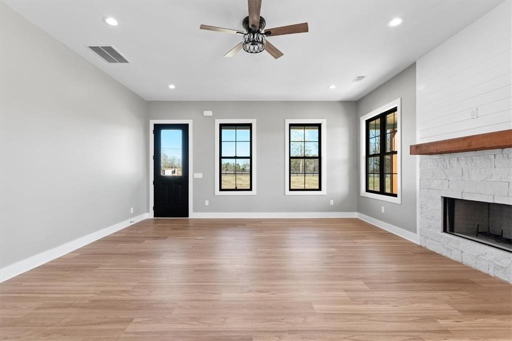 1237 Morgan Road Temple, GA 30179 - Photo 11 of 52 an empty room with windows and fireplace