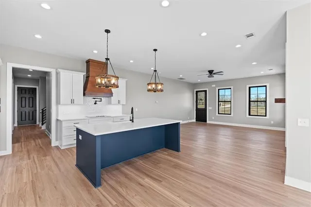 a view of kitchen and sink with wooden floor
