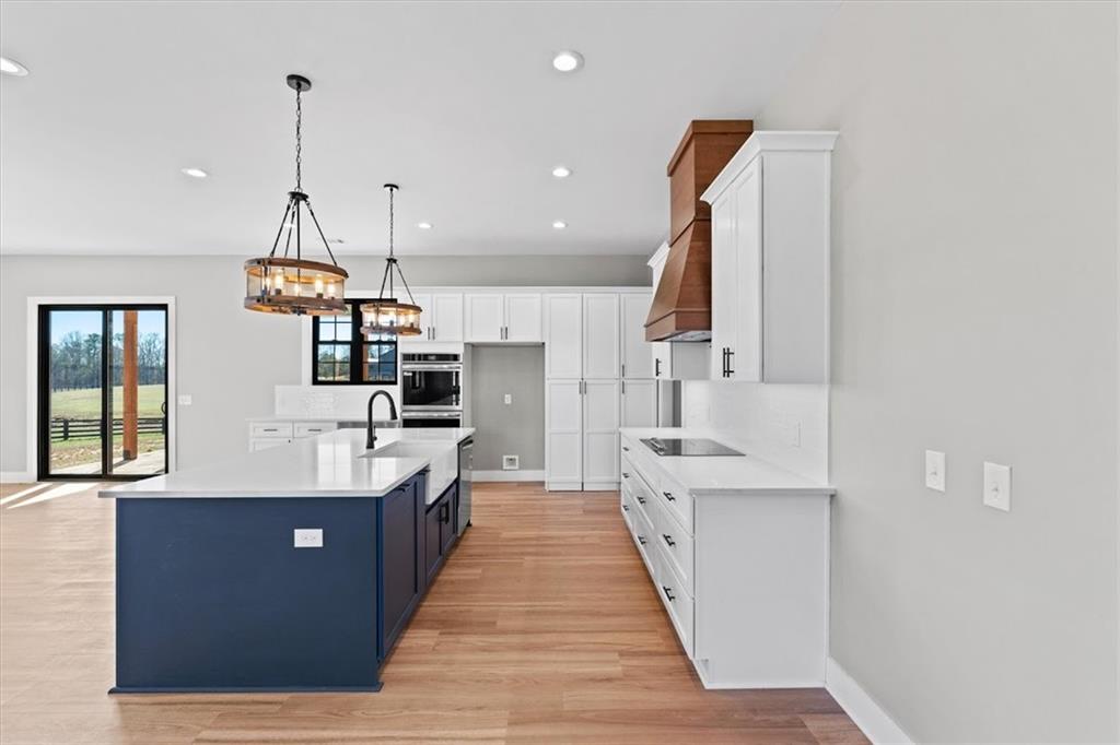 1237 Morgan Road Temple, GA 30179 - Photo 14 of 52 a large kitchen with stainless steel appliances kitchen island granite countertop a sink and cabinets