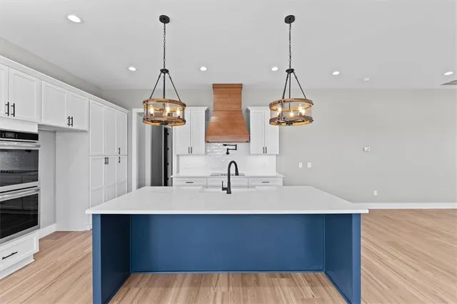 a very nice looking room with a chandelier furniture and wooden floor
