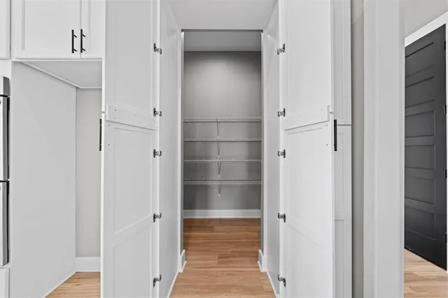 a view of an empty room with glass door and glass window