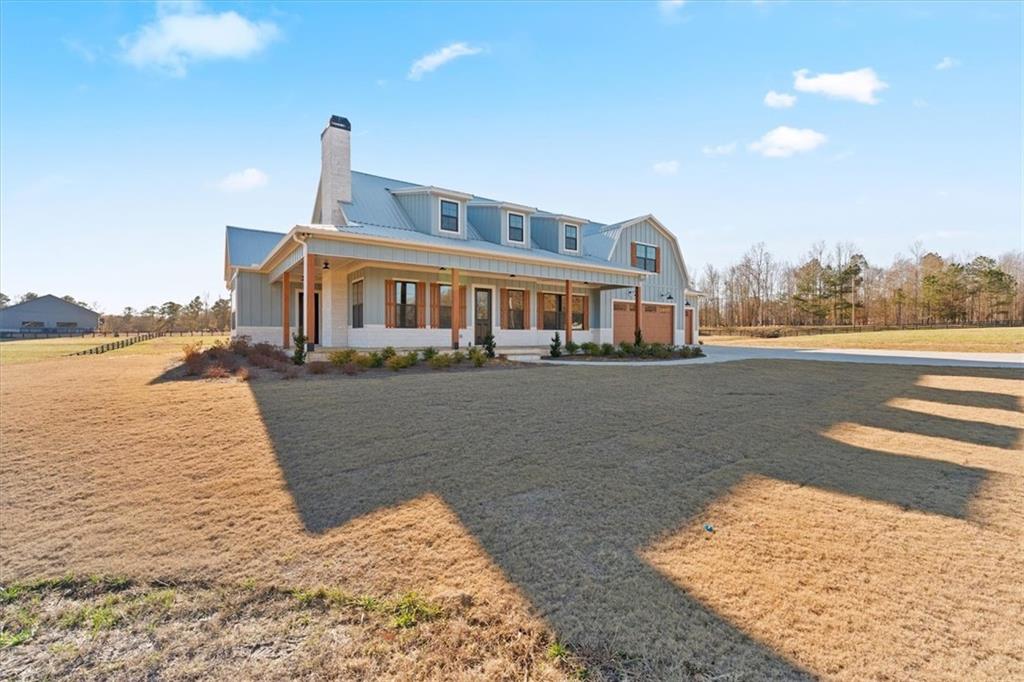 1237 Morgan Road Temple, GA 30179 - Photo 2 of 52 a front view of a house with a yard and lake view