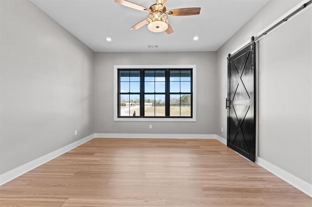 1237 Morgan Road Temple, GA 30179 - Photo 22 of 52 a view of an empty room with a window and wooden floor