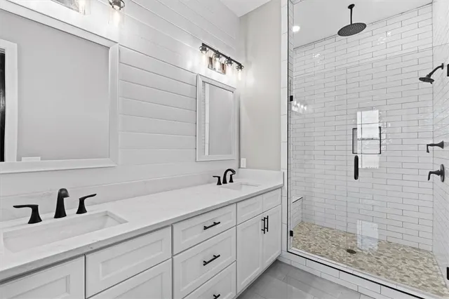 a bathroom with a double vanity sink and a mirror