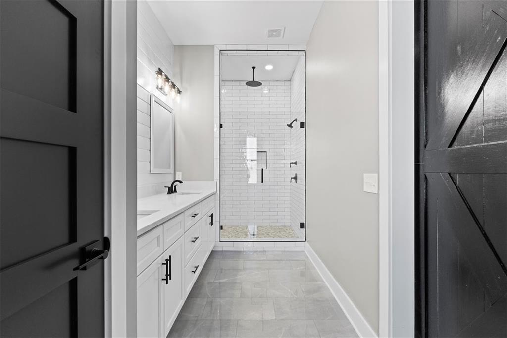 1237 Morgan Road Temple, GA 30179 - Photo 25 of 52 a bathroom with a double vanity sink and a mirror