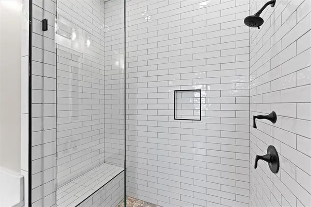 a bedroom with a bed and a mirror