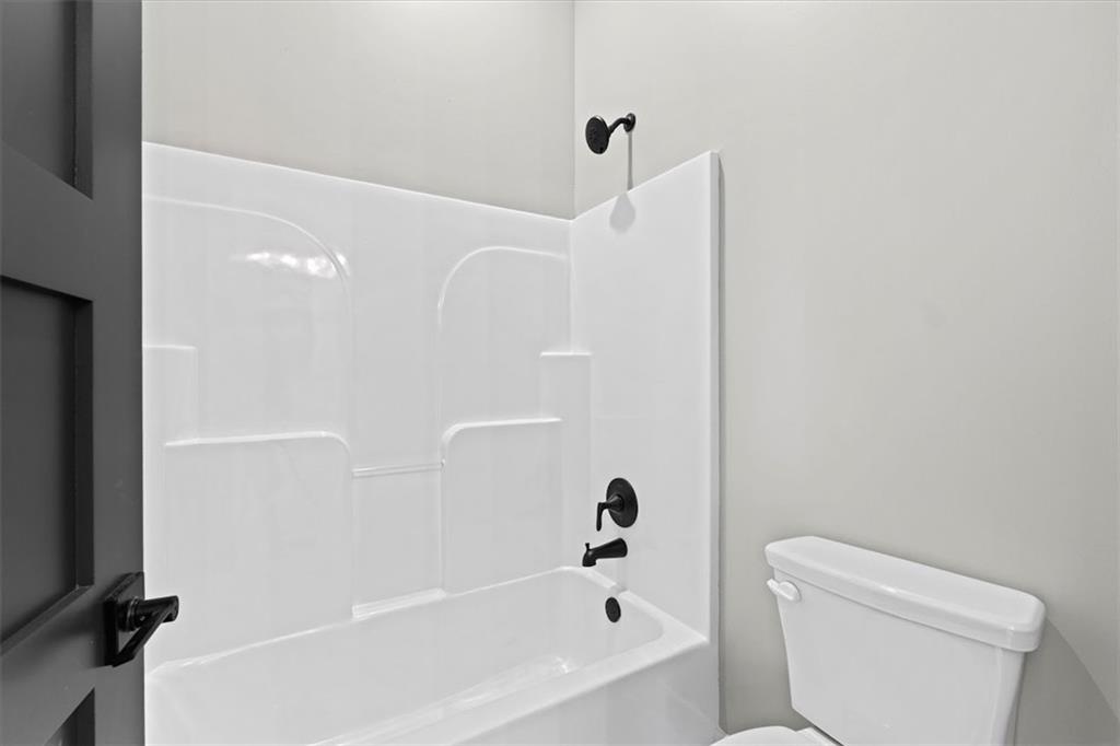 1237 Morgan Road Temple, GA 30179 - Photo 30 of 52 a bathroom with a bathtub and a toilet
