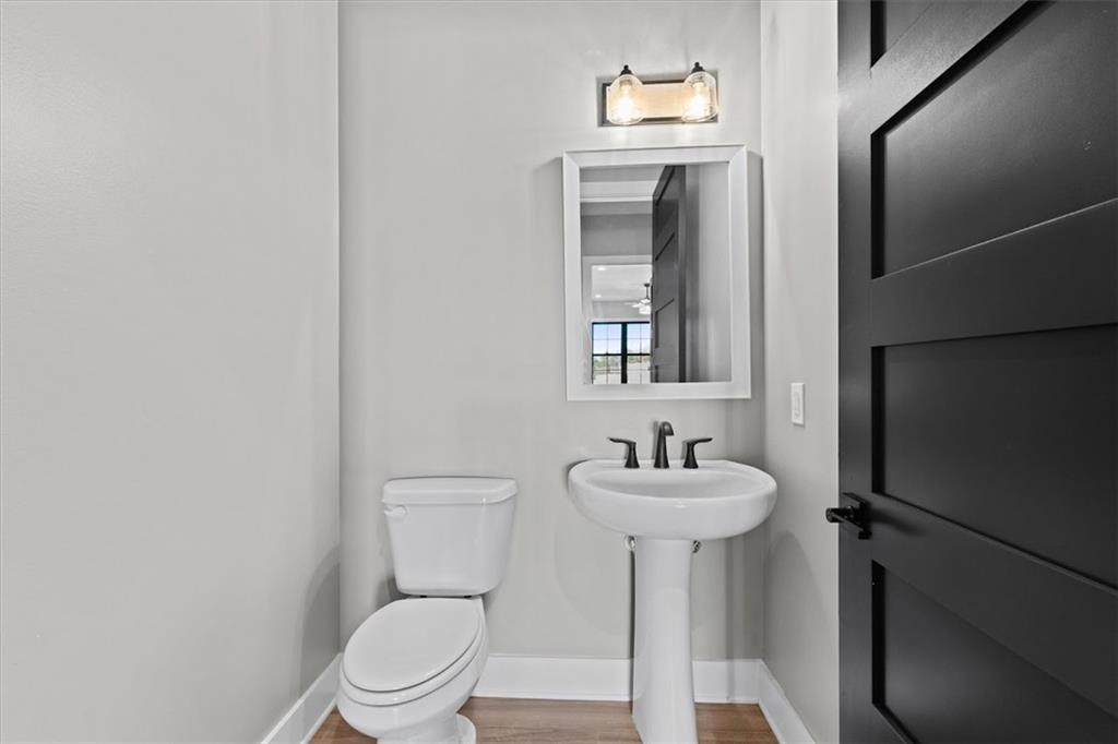 1237 Morgan Road Temple, GA 30179 - Photo 34 of 52 a bathroom with a toilet sink and mirror