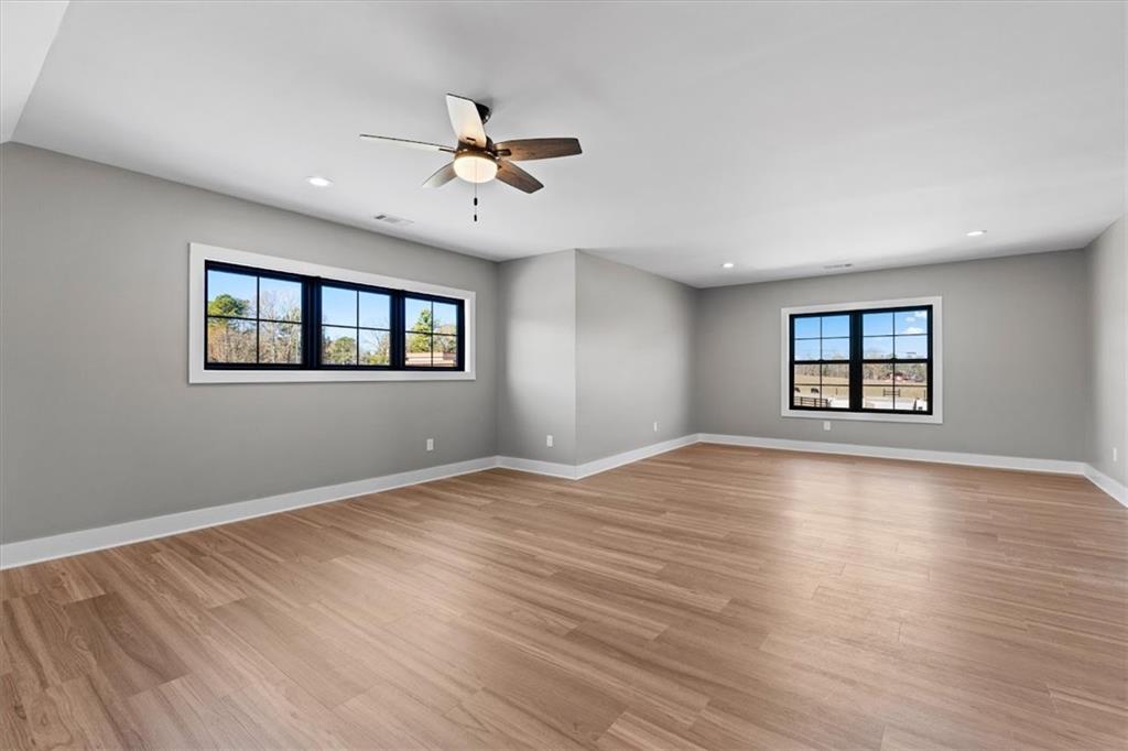 1237 Morgan Road Temple, GA 30179 - Photo 37 of 52 a view of an empty room with a window and wooden floor