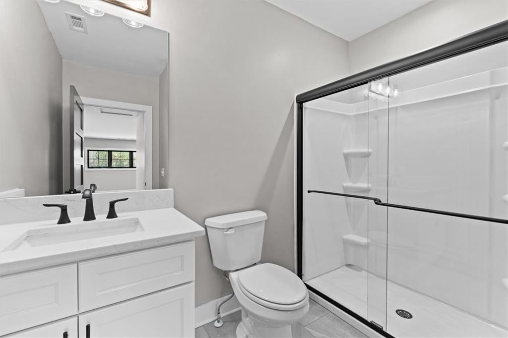 1237 Morgan Road Temple, GA 30179 - Photo 40 of 52 a bathroom with a toilet a sink and a mirror