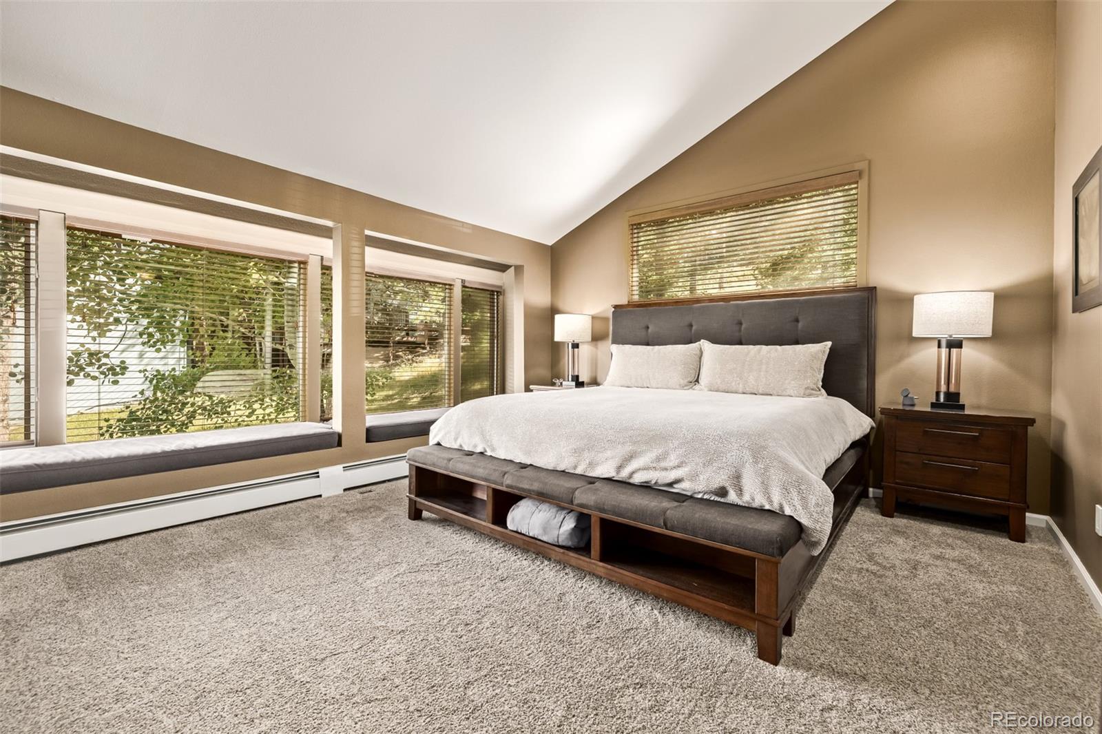 1139 Genesee Vista Road Golden, CO 80401 - Photo 22 of 43 a spacious bedroom with a bed lamp and window