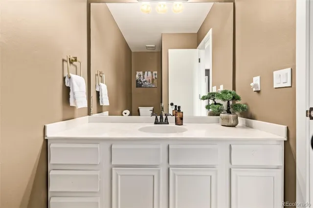 a bedroom with a bed and a large mirror