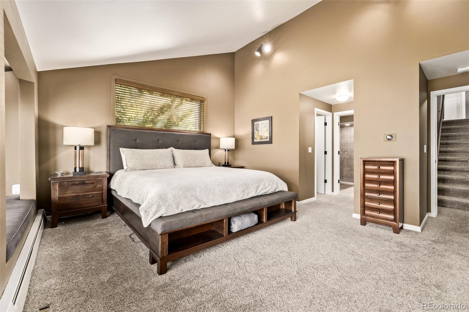 1139 Genesee Vista Road Golden, CO 80401 - Photo 23 of 43 a bedroom with a bed and a large mirror