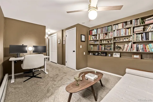 a living room with furniture and a book shelf