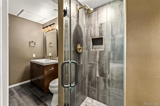 a bathroom with a double vanity sink mirror and shower