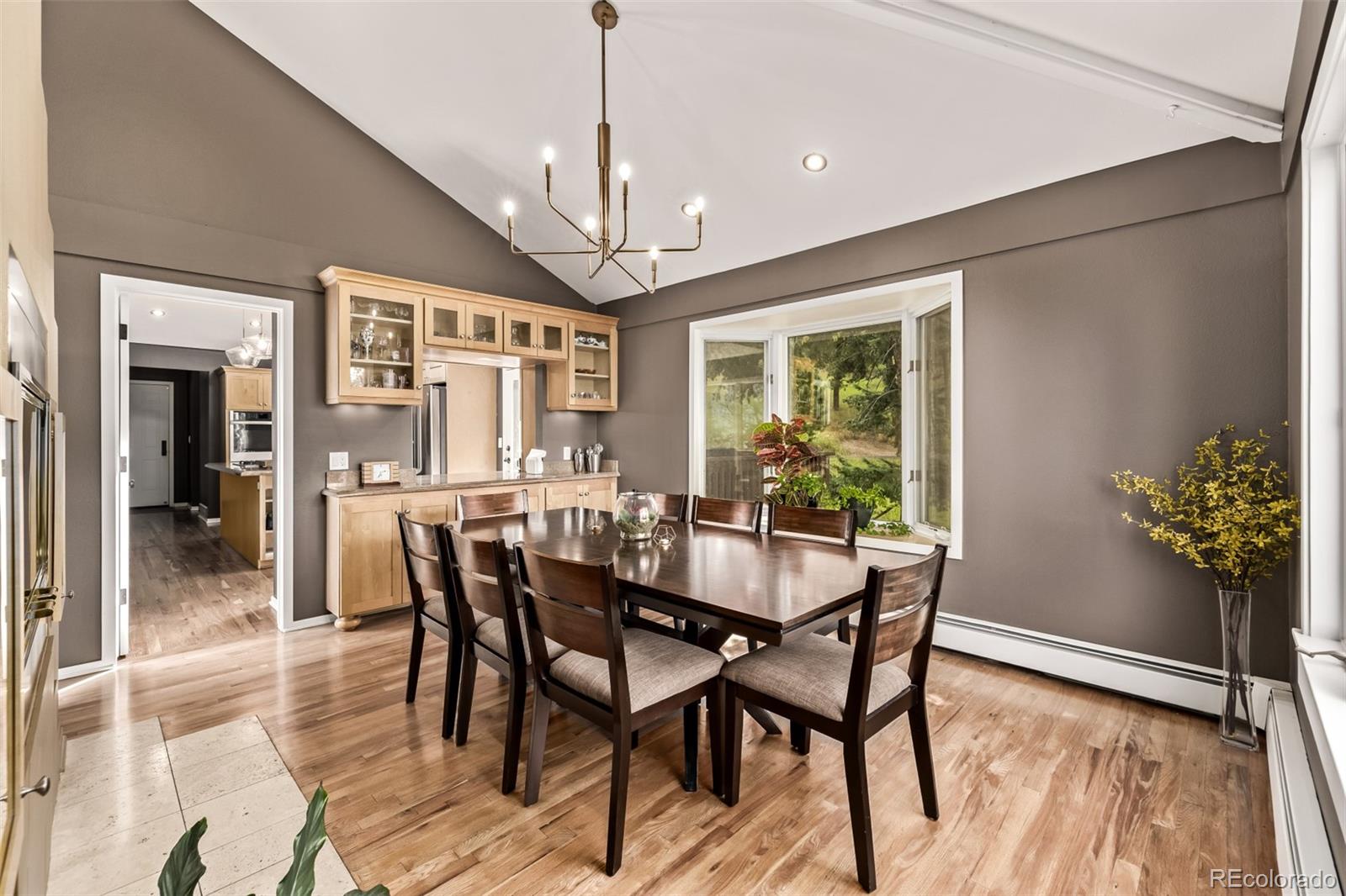 1139 Genesee Vista Road Golden, CO 80401 - Photo 10 of 43 a view of a dining room with furniture window and wooden floor