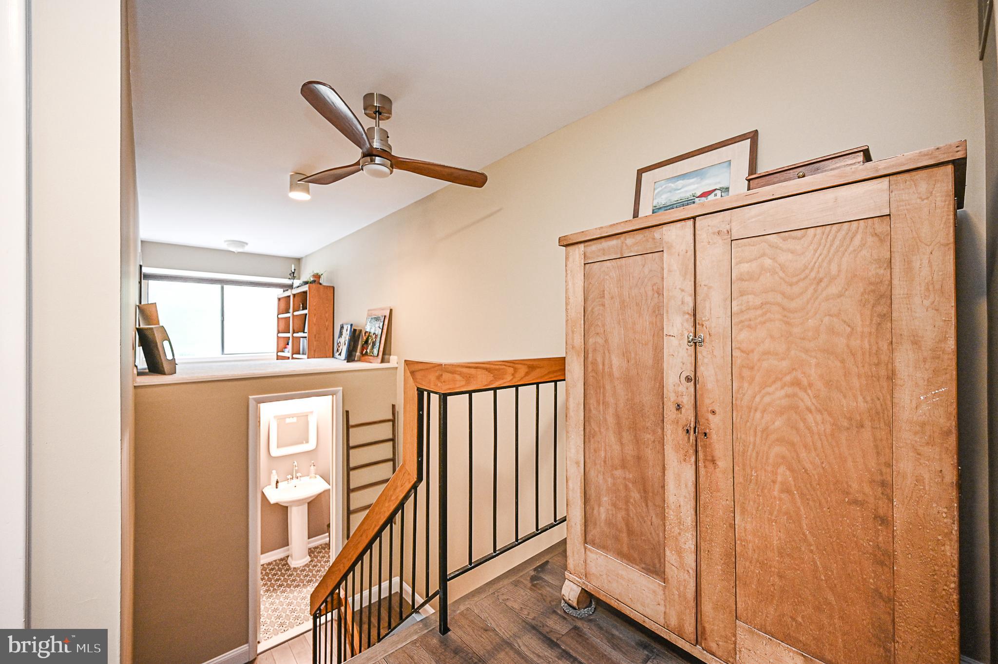 12013 Insha Court Reston, VA 20191 - Photo 18 of 35 Upper level hall with a glimpse of the powder room