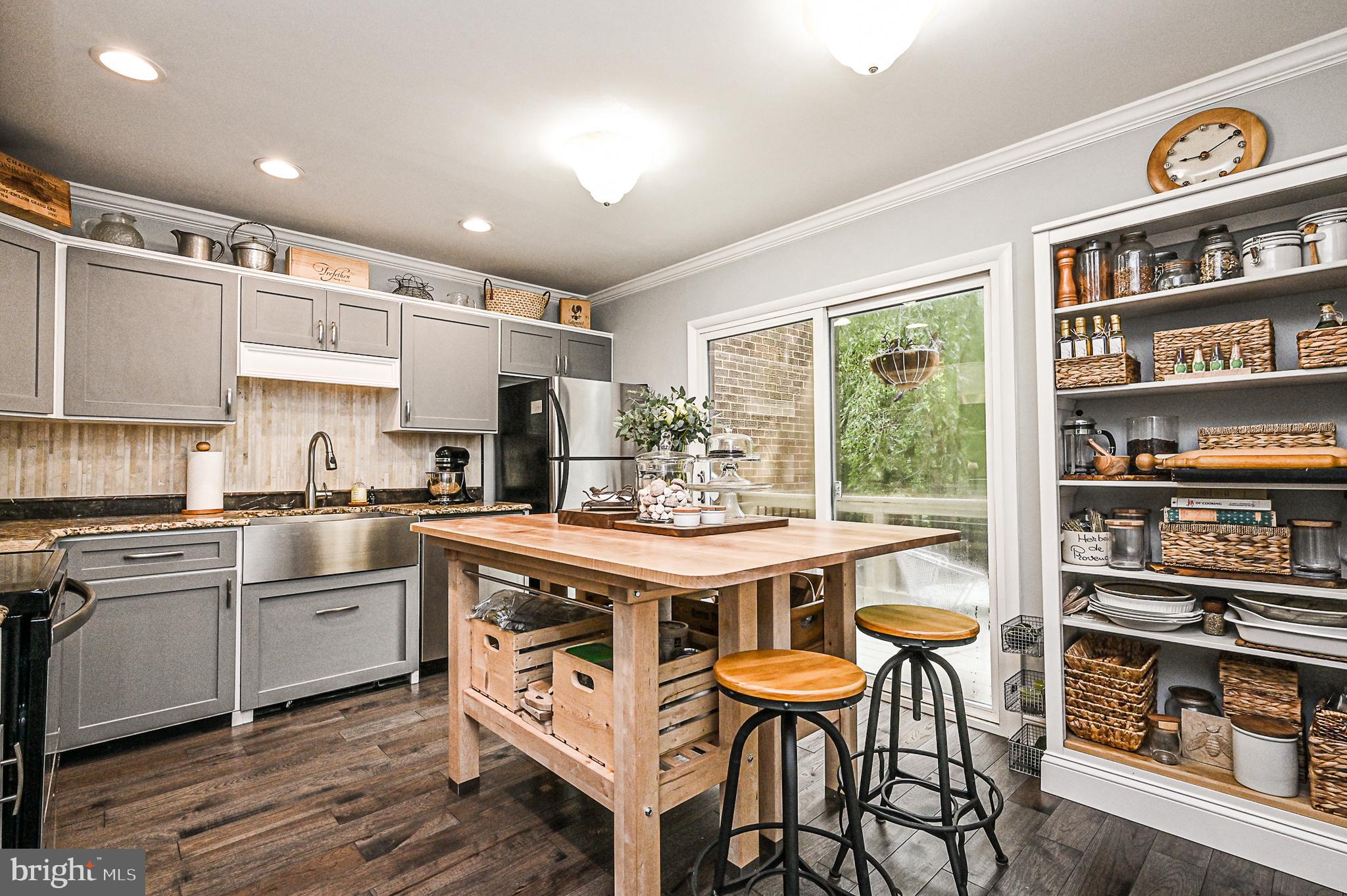 12013 Insha Court Reston, VA 20191 - Photo 9 of 35 Kitchen with island, bookcase & farmhouse sink!