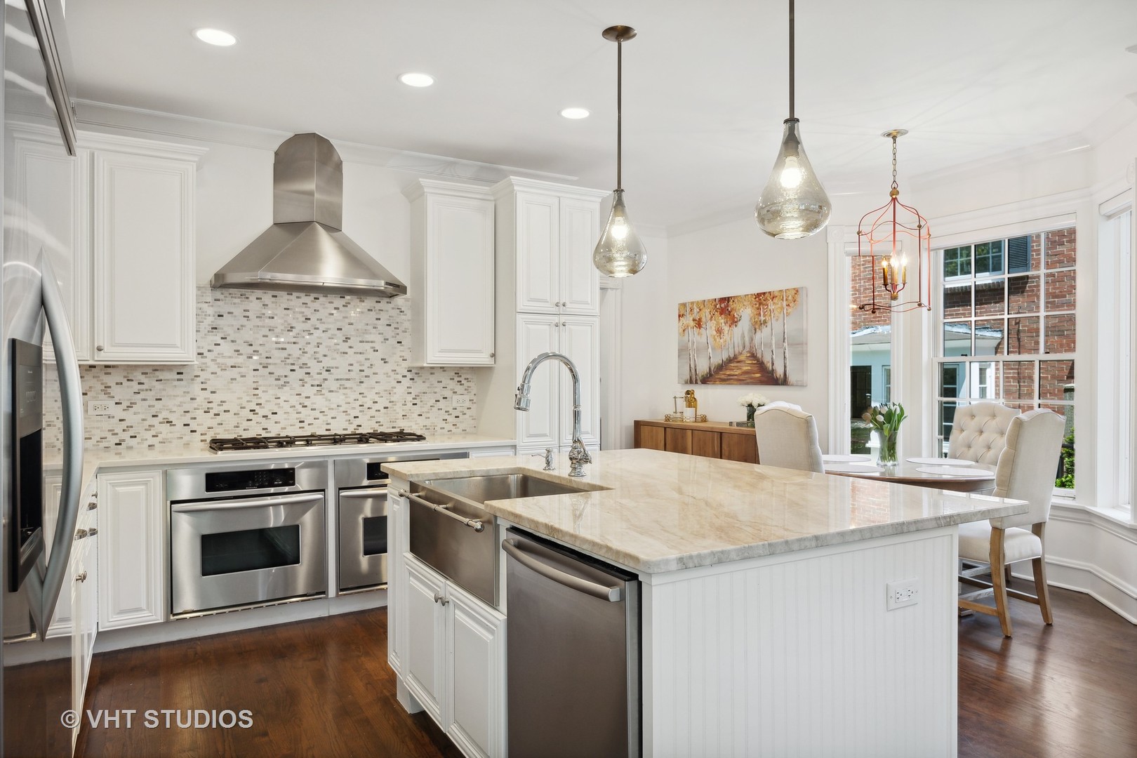 576 Sunset Road Winnetka, IL 60093 - Photo 11 of 42 a kitchen with stainless steel appliances granite countertop a stove a sink and a wooden floor
