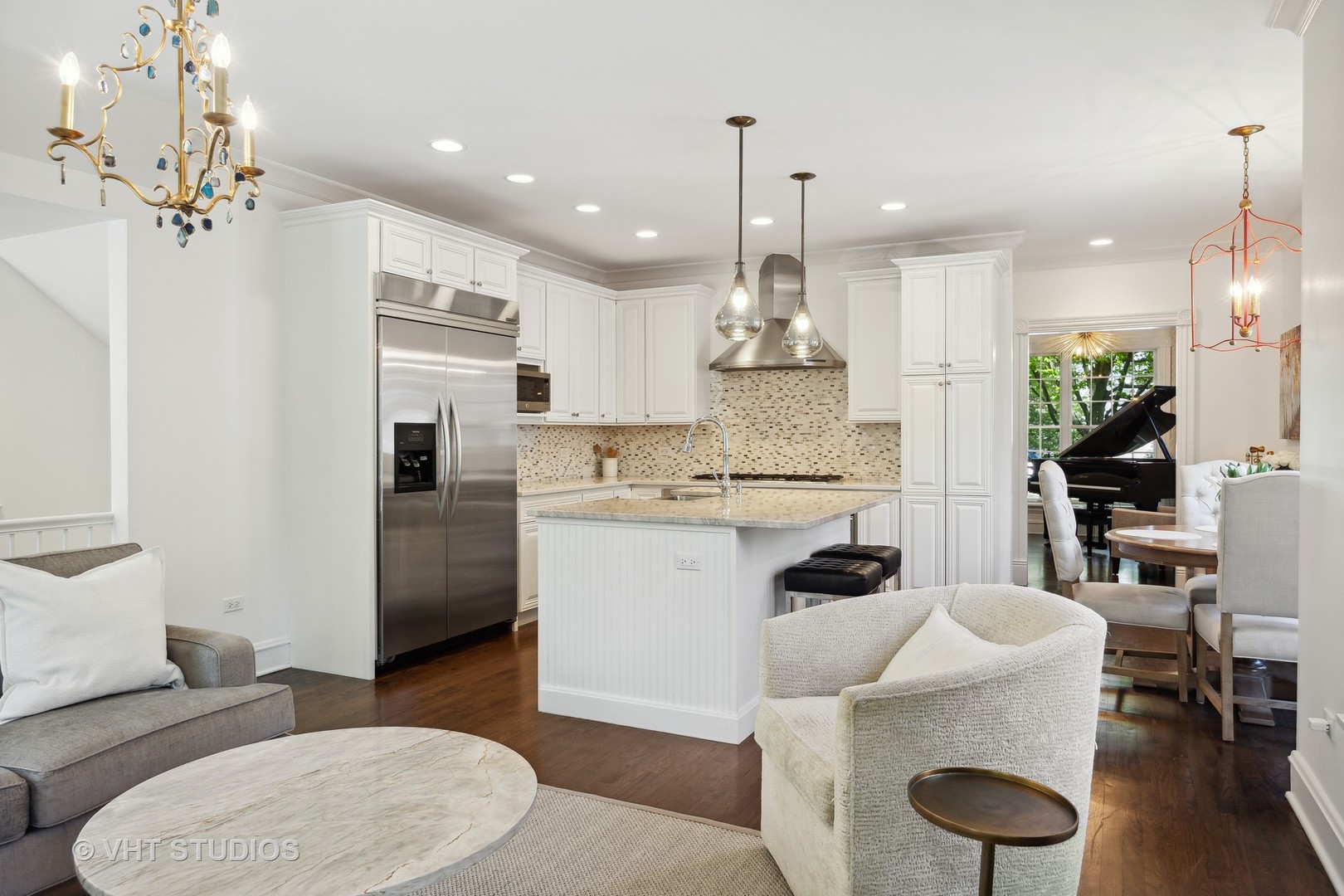 576 Sunset Road Winnetka, IL 60093 - Photo 12 of 42 a kitchen with stainless steel appliances kitchen island granite countertop a sink a refrigerator and a dining table with wooden floor