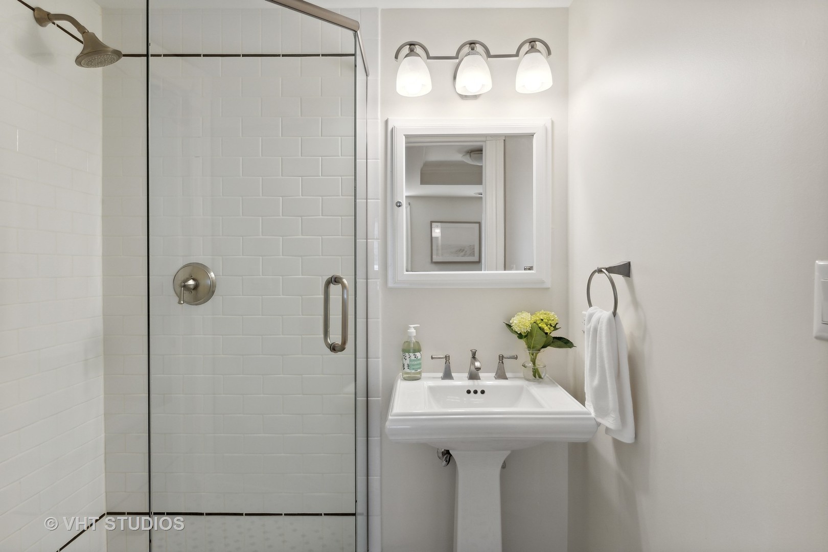 576 Sunset Road Winnetka, IL 60093 - Photo 35 of 42 a bathroom with a sink a mirror and a shower