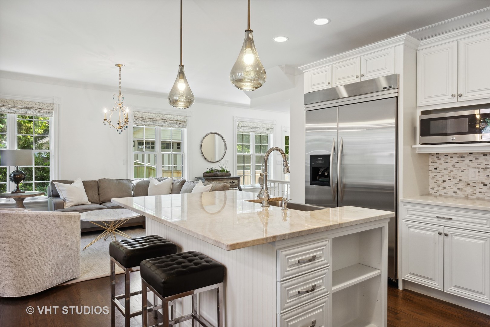 576 Sunset Road Winnetka, IL 60093 - Photo 10 of 42 a open kitchen with stainless steel appliances granite countertop a sink a stove a refrigerator cabinets and chairs