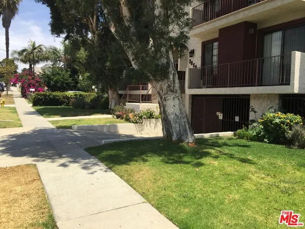 a view of backyard of house with green space