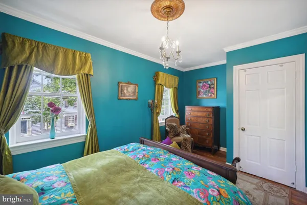 a bedroom with a bed and a dresser in it