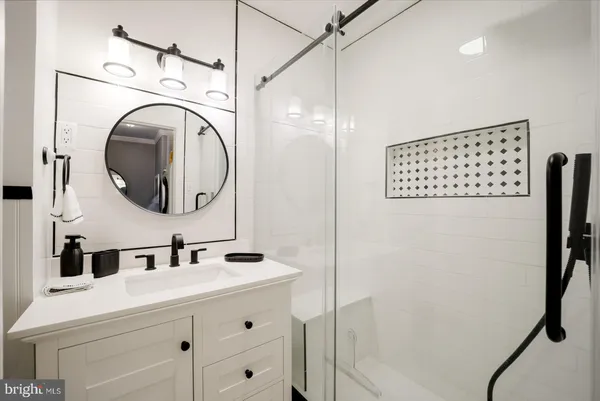 a bathroom with a sink vanity and a mirror