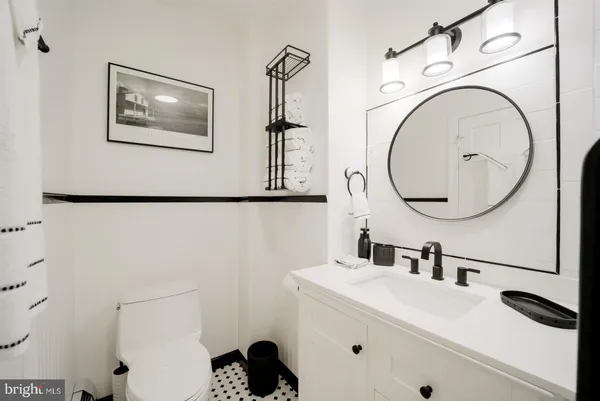a bathroom with a sink mirror and vanity