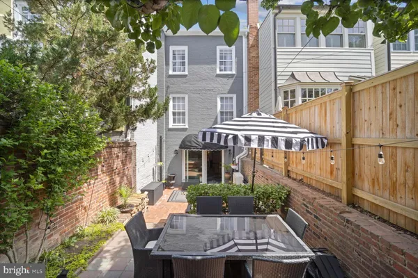 a front view of a house with yard and furniture