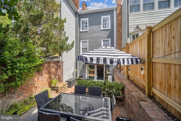 a view of house with furniture and outdoor seating