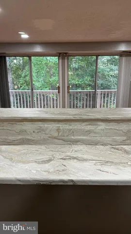 a kitchen with a sink a stove cabinets and a window