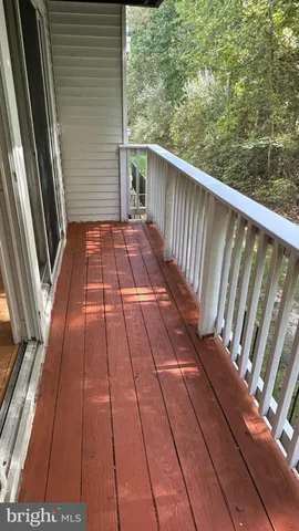 a view of balcony with wooden floor